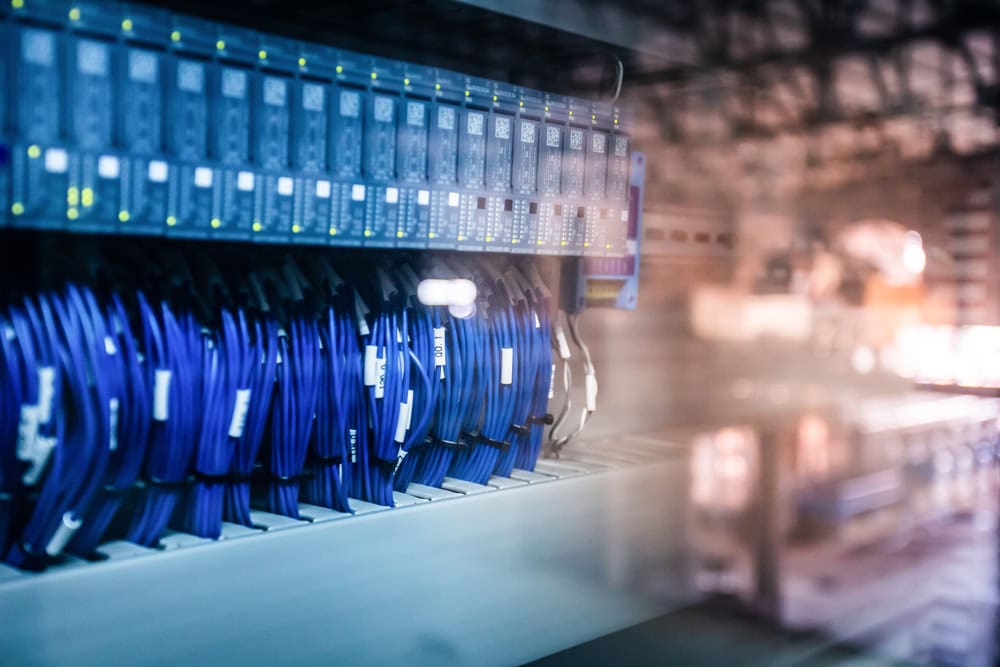 Main,Distribution,Board,Electric,Wiring,With,Factory,Structure,On,Background.
